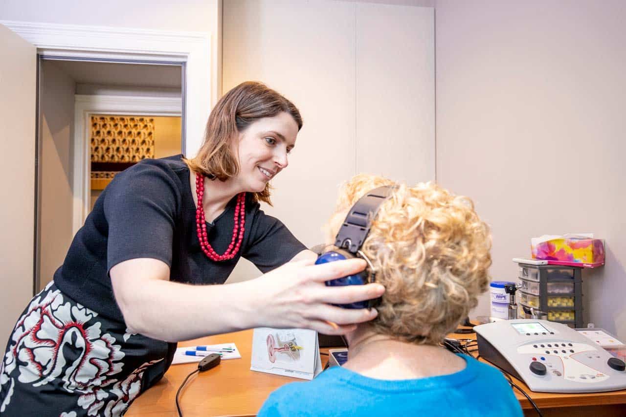 An Audiologist Conducting A Hearing Test