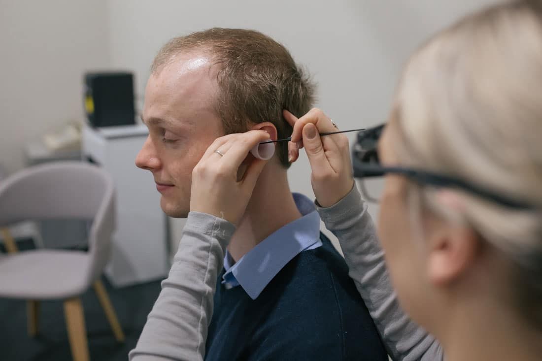 Man Receiving Ear Wax Treatment
