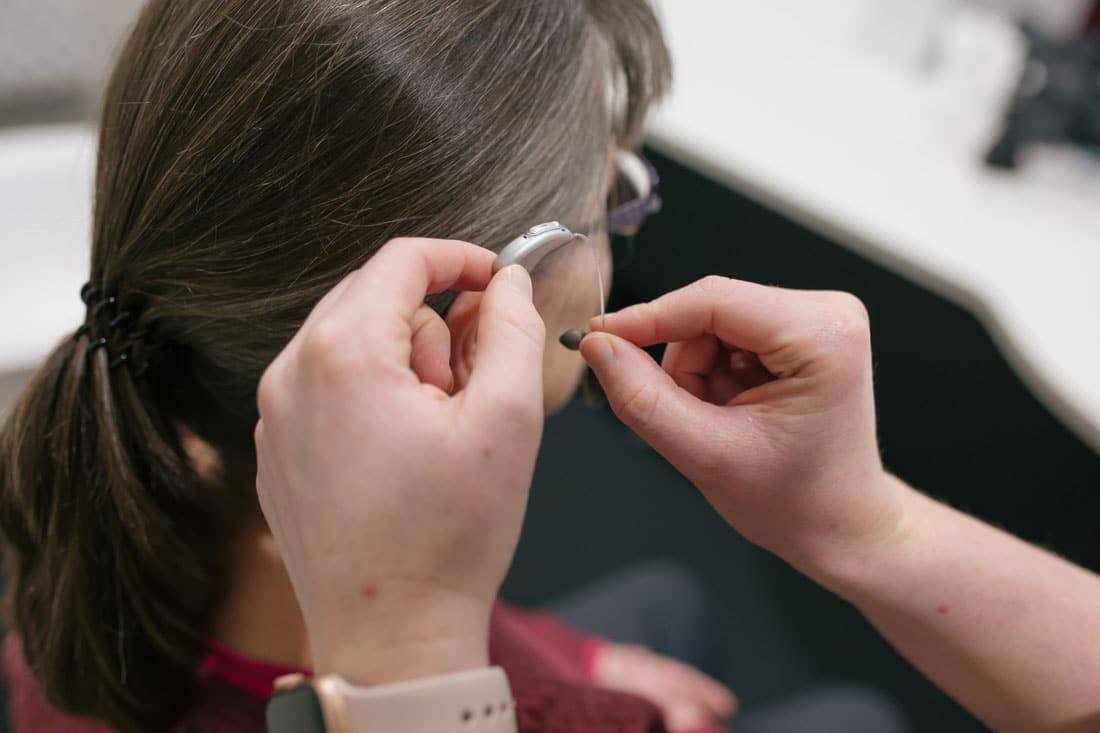 Woman Getting Hearing Aid Fitted