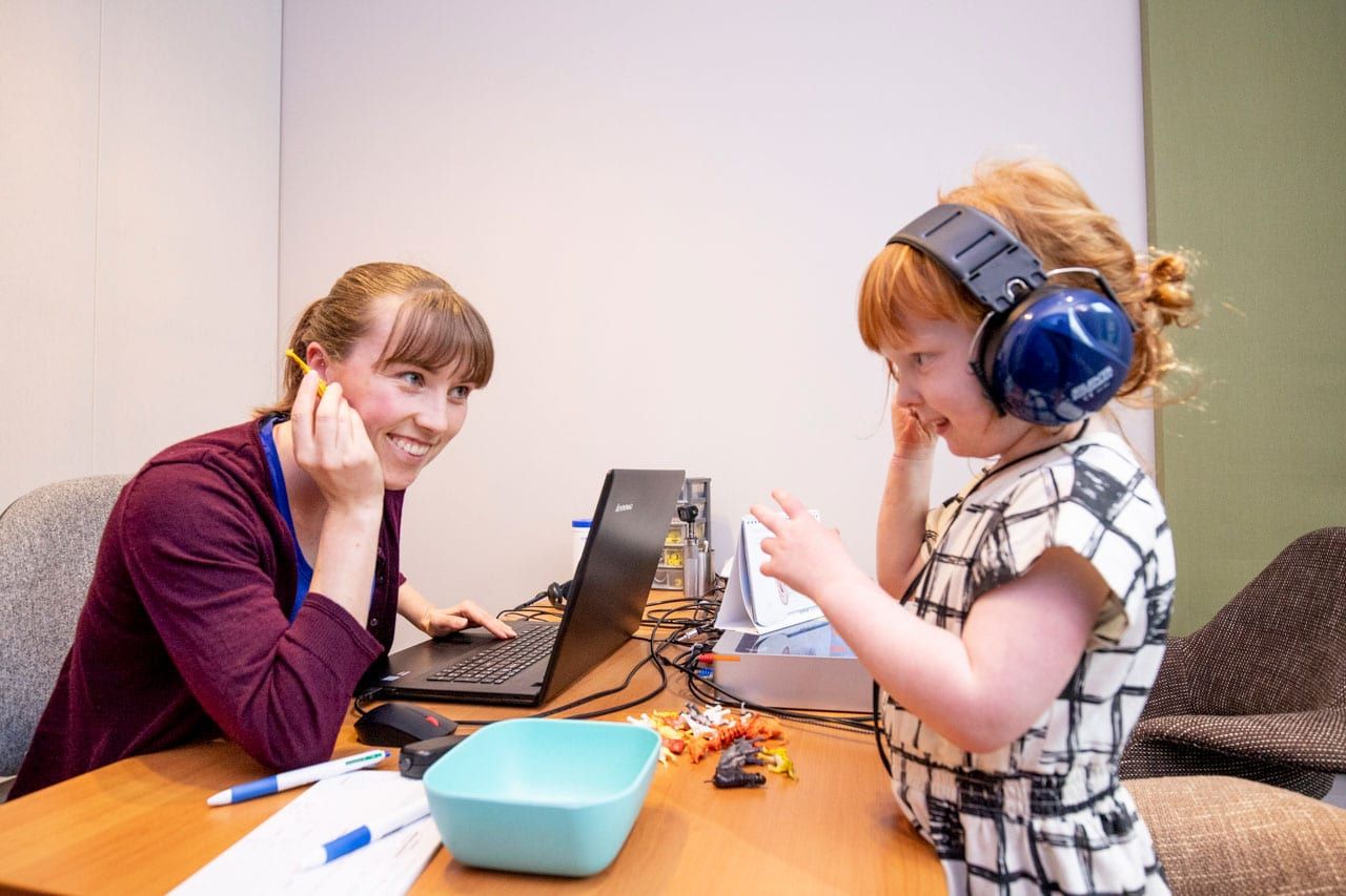 An Audiologist Conducting A Hearing Test for a Young Girl