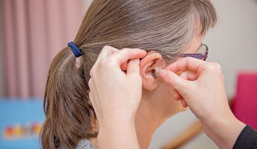 A Woman Having a Hearing Aid Fitting