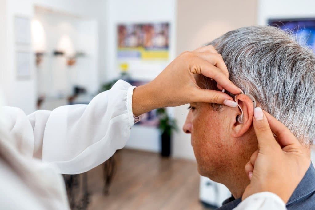 Man Getting Hearing Aid Fitted
