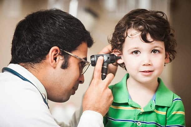 Audiologist performing a hearing test on a child