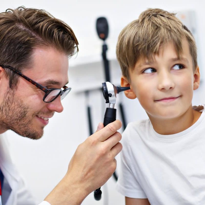 Audiologist performing a hearing test on a child