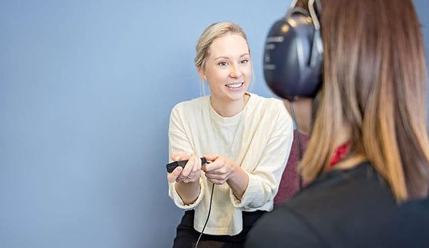 An Audiologist Conducting A Hearing Test